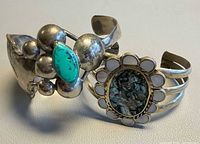 Both cuff bracelets side by side showing overall designs and stones