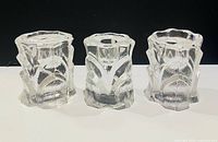 Front view of three Orrefors Capella crystal candle holders
