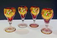 Four ruby red goblets with gold and enamel decoration