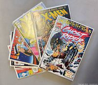 Stack of eight bagged comic books, Ghost Rider cover visible on top