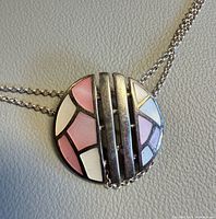 Front view of pendant showing enamel colors and chain