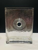 Front view of rectangular clear glass vase showing central circular through-hole and textured surface