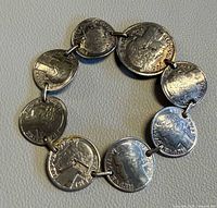 Full view of bracelet showing seven linked French coins
