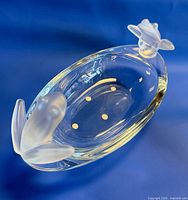 Top view of clear oval crystal bowl with two frosted frogs