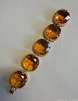 Top view showing five large amber glass links on bracelet