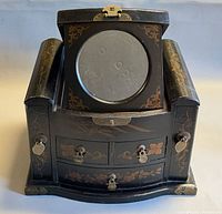 Box with lid open showing interior mirror and drawers