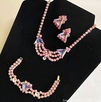 Full view of necklace, bracelet and earrings on display stand