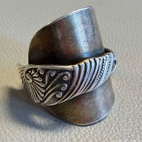 Front view of sterling wrap ring showing ornate scroll pattern