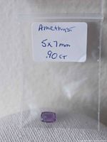 Amethyst gemstone in labeled plastic bag showing size and weight