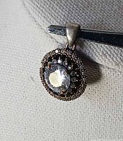 Front view showing white topaz centre and CZ halo