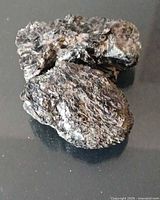 Both biotite specimens on surface, showing overall shape and color