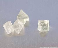 Four fluorite cubic crystals displayed on surface