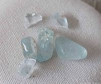 Group of seven blue lace agate stones showing size variation and finish