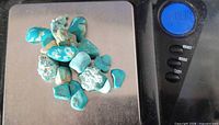 All turquoise pieces on scale showing 14.30 g