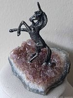 Front view of amethyst cluster with pewter unicorn