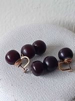 Both earrings showing triple dark beads and gold-tone screw backs