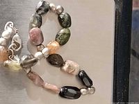 Full view of bracelet showing multicolour tourmaline beads and clasp