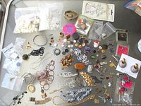Overview of entire mixed jewelry lot spread on table
