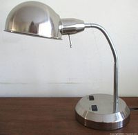 full view of chrome dome lamp on wooden surface