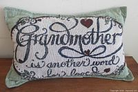 Front view of tapestry pillow showing full design and text