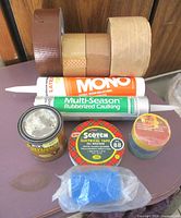Overall view showing caulk tubes, stain can, various tape rolls