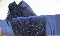 Full view of bolt showing navy blue velvet fabric rolled