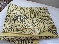 Folded length of yellow animal-print stretch fabric