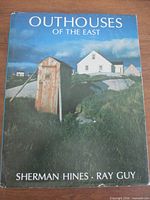 Front cover with title, authors Sherman Hines and Ray Guy, image of outhouse