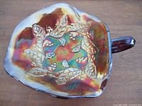 Top view showing iridescent surface and raised Berries & Leaves pattern