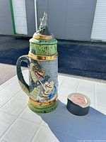 Full view of stein beside tape roll for scale