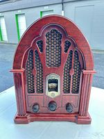 Front view showing cabinet design, speaker grille, tuning dial and control knobs