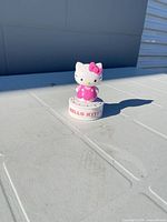 Front view of Hello Kitty timer standing on white surface
