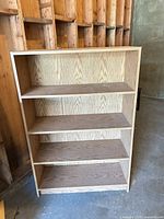 Full view of light oak bookcase front