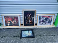 All four framed prints displayed together outdoors