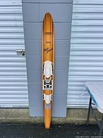 Full front view of Lund Chuck Stearns Tahoe wood water ski leaning against wall