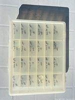 Closed translucent 24-compartment organizer box showing exterior