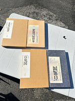 Front view showing both books with slipcases and title labels