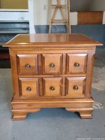 Front view showing two drawers, knobs, panel design, feet