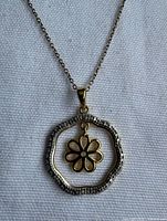 Pendant close-up showing two-tone design and cubic zirconia