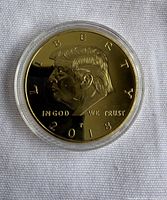 Obverse of gold-plated Donald Trump coin in capsule