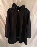 Full view of the black hooded jacket hanging, showing front and length