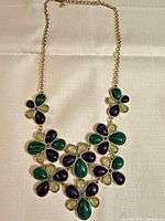 Full view of necklace showing floral design and cabochon colours