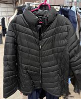 Front view of black Faded Glory puffer jacket on hanger