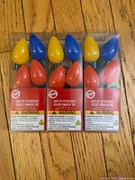 Front view of three packaged LED bulb necklaces showing colours and warning labels