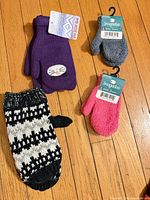 All four pairs laid out on wood floor showing colors, tags attached