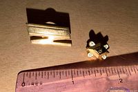 Both pins next to ruler, showing size and design