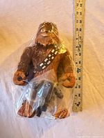 Front view of sealed Chewbacca figure with ruler for scale