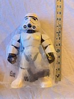 Front view of sealed 11" Stormtrooper figure beside ruler