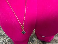 Full view of gold-plated rope chain necklace on display bust