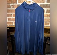 Front of Vineyard Vines blue quarter zip pullover showing whale logo and red zipper pull